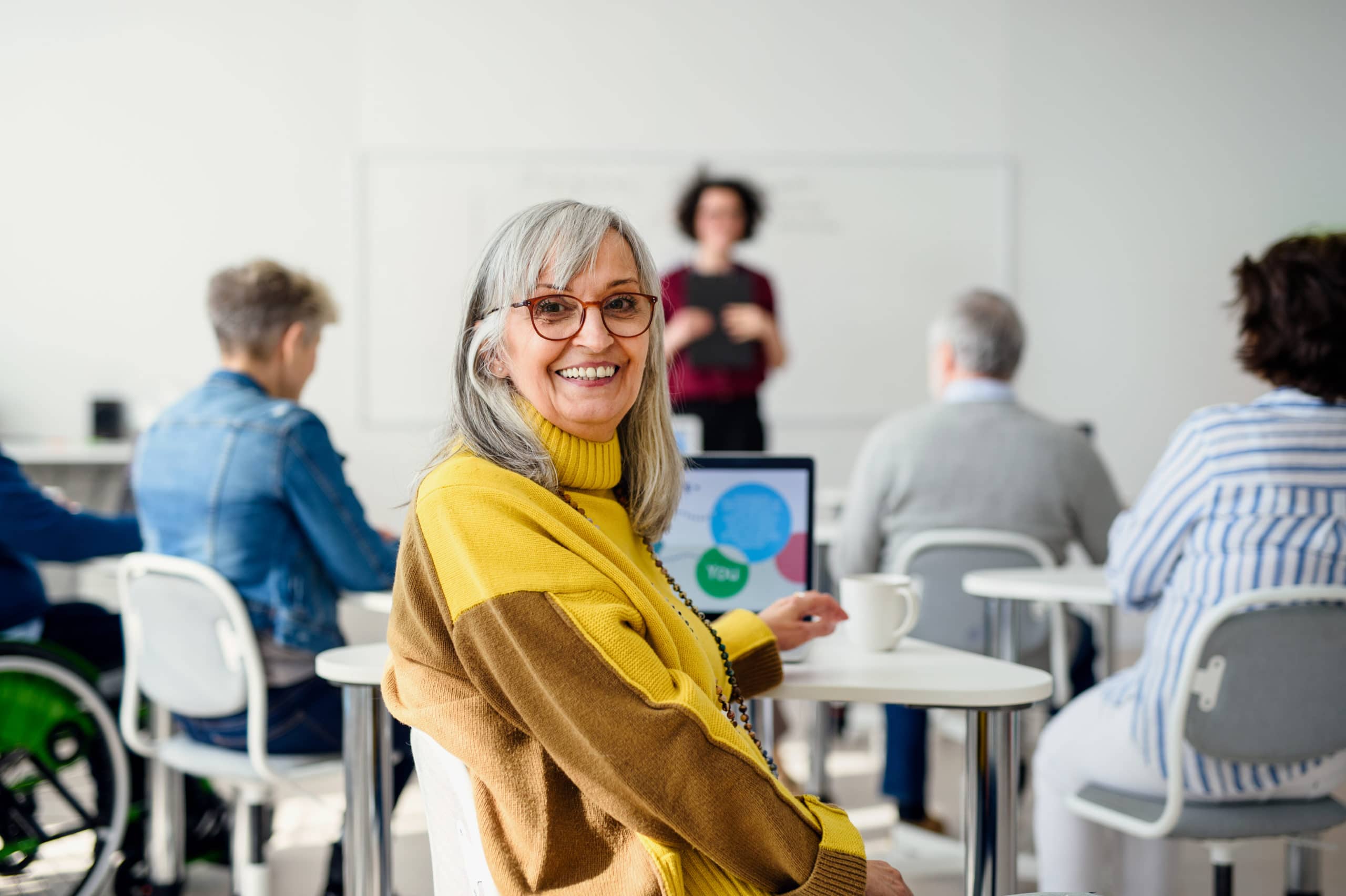 Portrait of senior attending computer and technology education class.